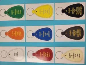 Colorful sobriety keychains on display board.